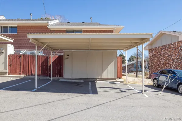 a view of a building with car parked