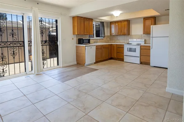 a large kitchen with cabinets and stainless steel appliances