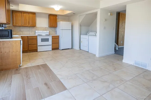 a large kitchen with cabinets and stainless steel appliances