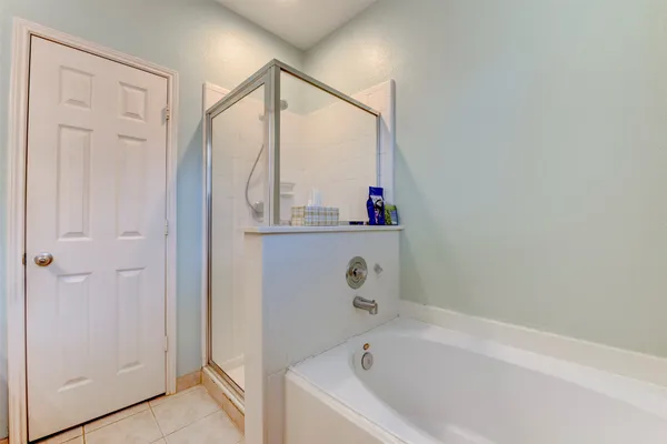 a bathroom with a bathtub and a shower