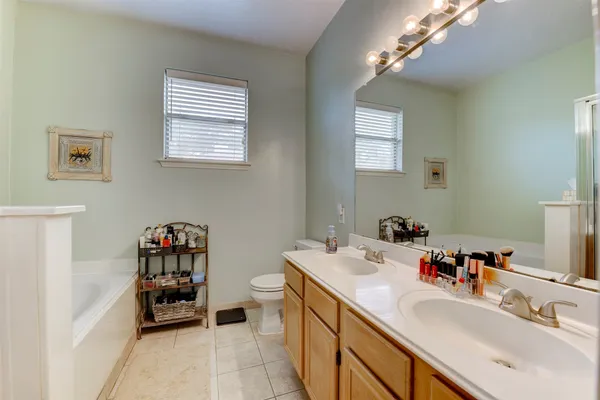 a bathroom with a sink double vanity and a mirror
