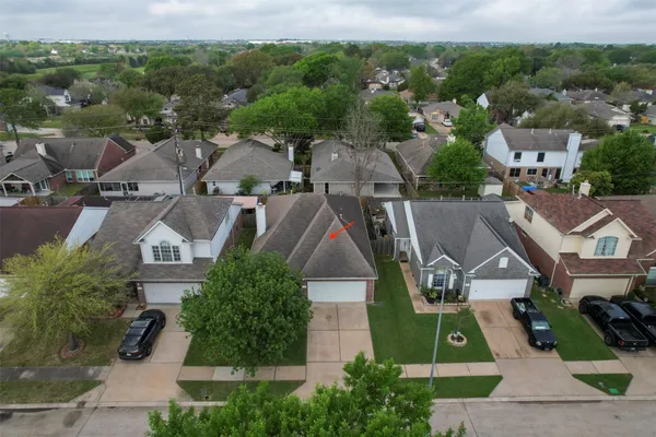 an aerial view of residential houses with outdoor space and street view