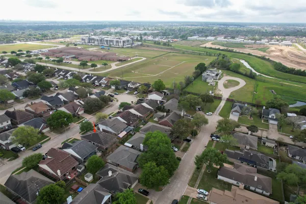 an aerial view of residential houses with outdoor space