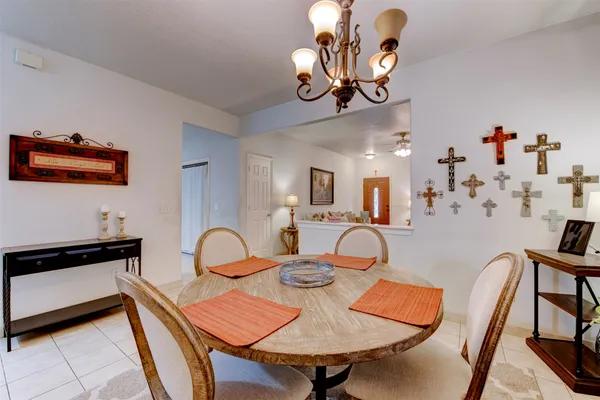 a view of a dining room with furniture and chandelier