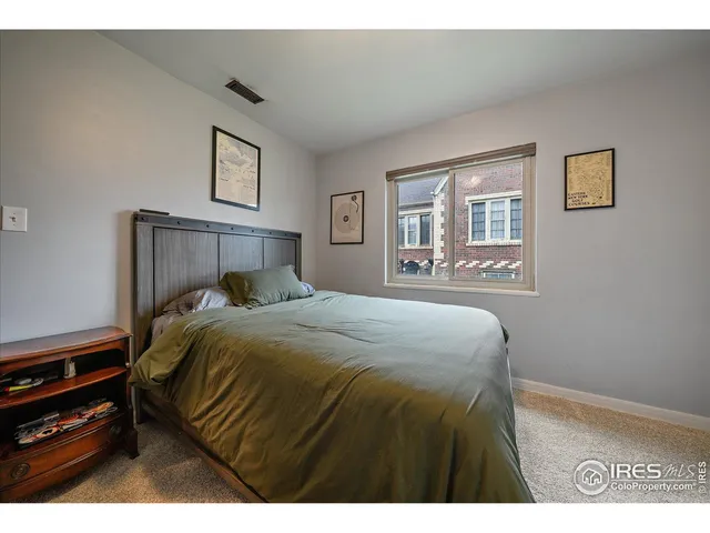 a bedroom with a bed and a night stand