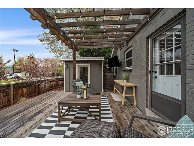 a view of a patio with table and chairs with wooden floor