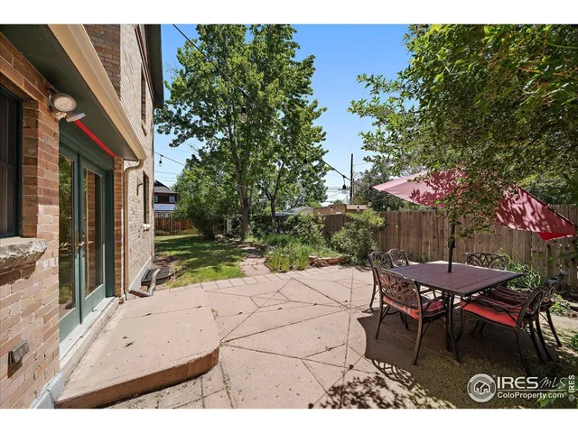 a view of a patio with table and chairs and potted plants