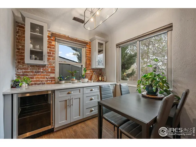 a kitchen with a table chairs and cabinets