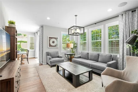 a living room with furniture large window and flat screen tv