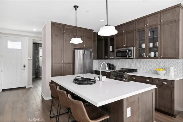 a kitchen that has a table and chairs in it