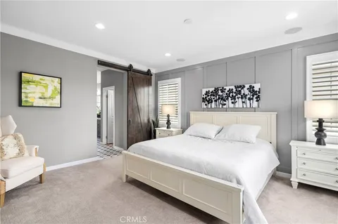 a bedroom with a large bed and a couch