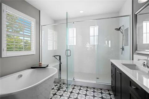 a bathroom with a tub a sink and a shower