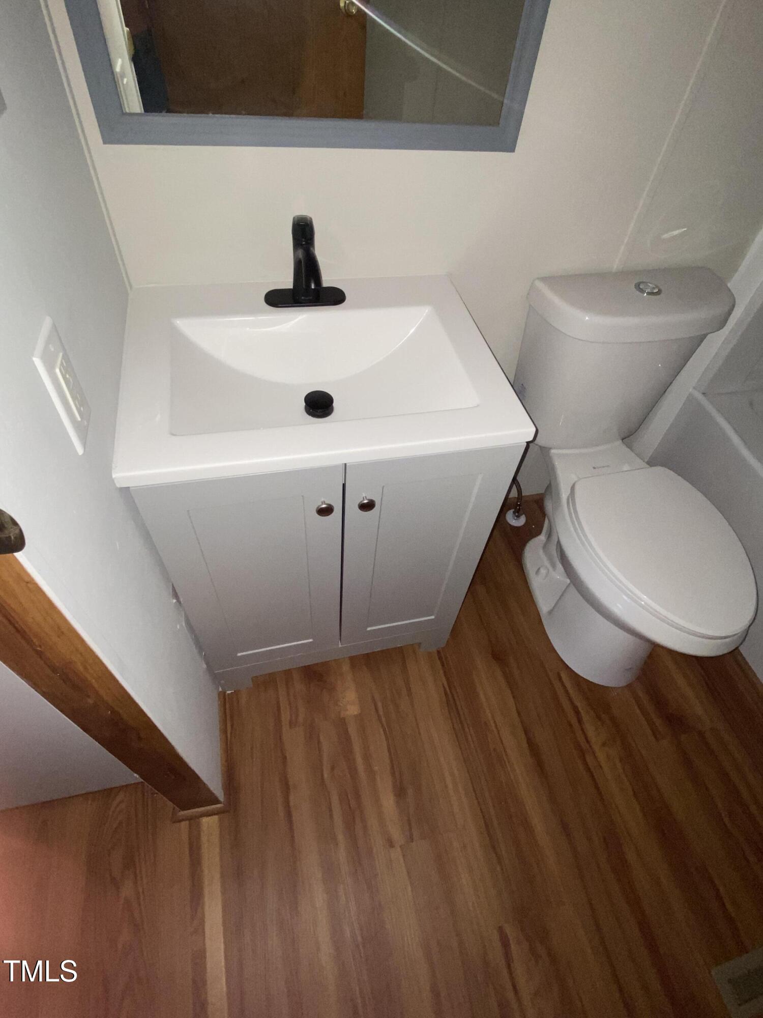 2020 Sanders Road Stem, NC 27581 - Photo 12 of 23 a bathroom with a sink and a toilet