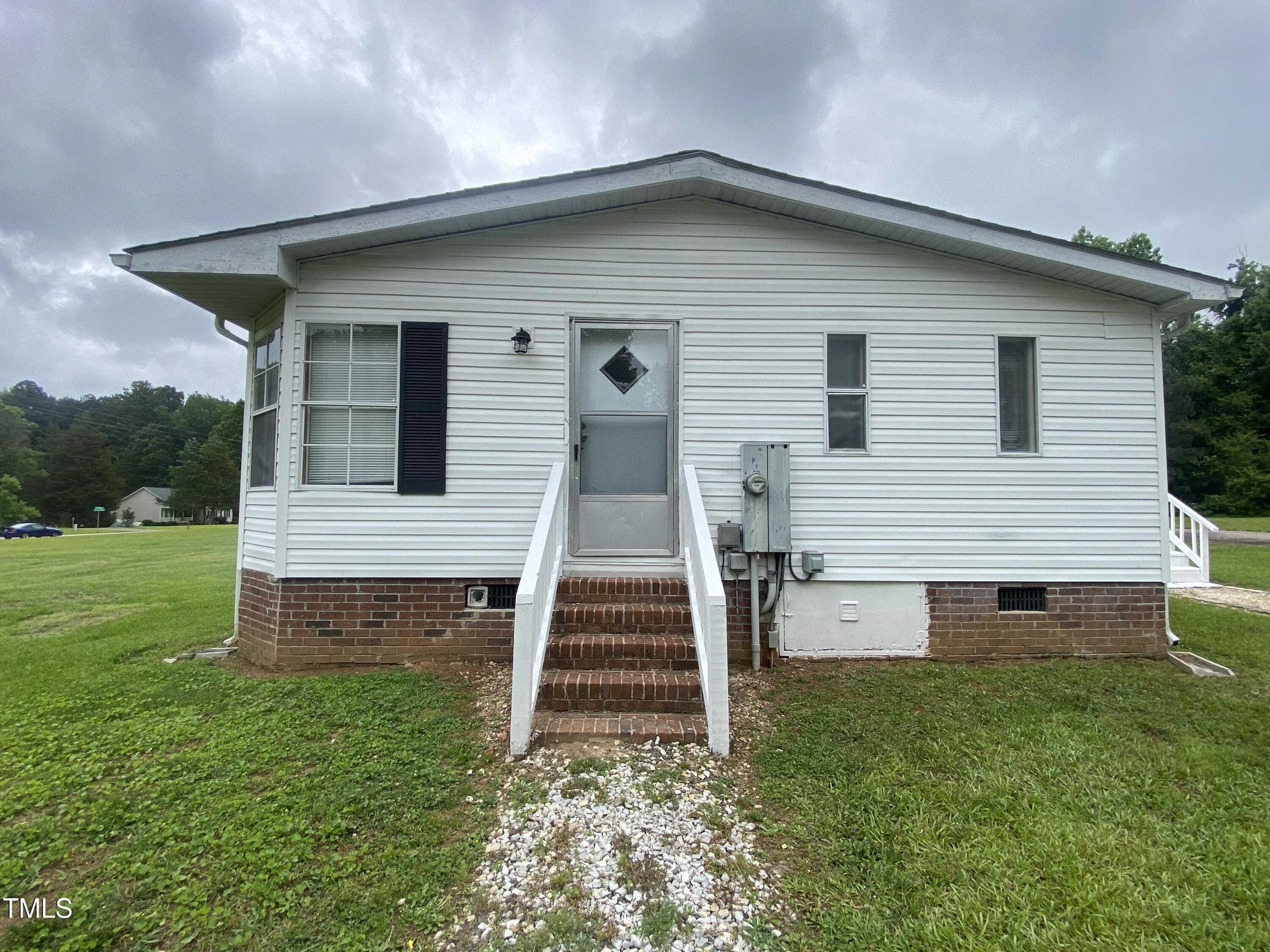 2020 Sanders Road Stem, NC 27581 - Photo 17 of 23 a front view of a house with a yard