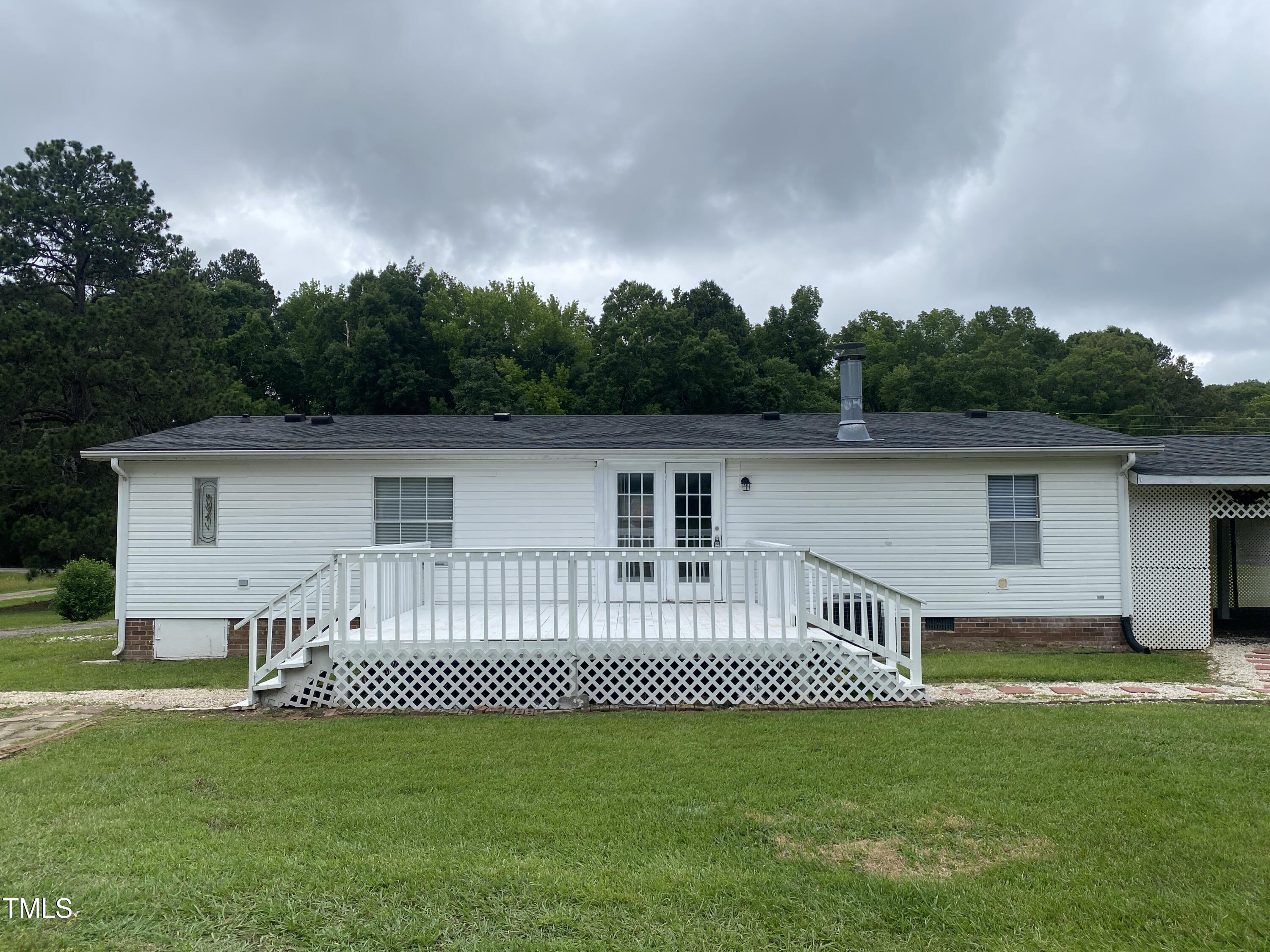 2020 Sanders Road Stem, NC 27581 - Photo 18 of 23 a view of a backyard with a garden
