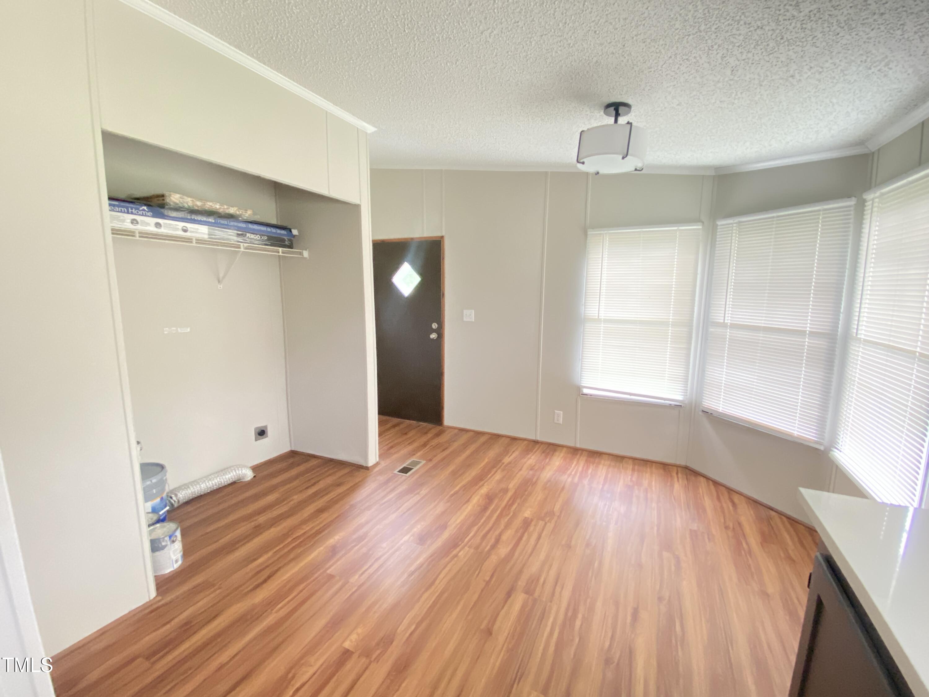 2020 Sanders Road Stem, NC 27581 - Photo 5 of 23 a view of empty room with wooden floor and fan