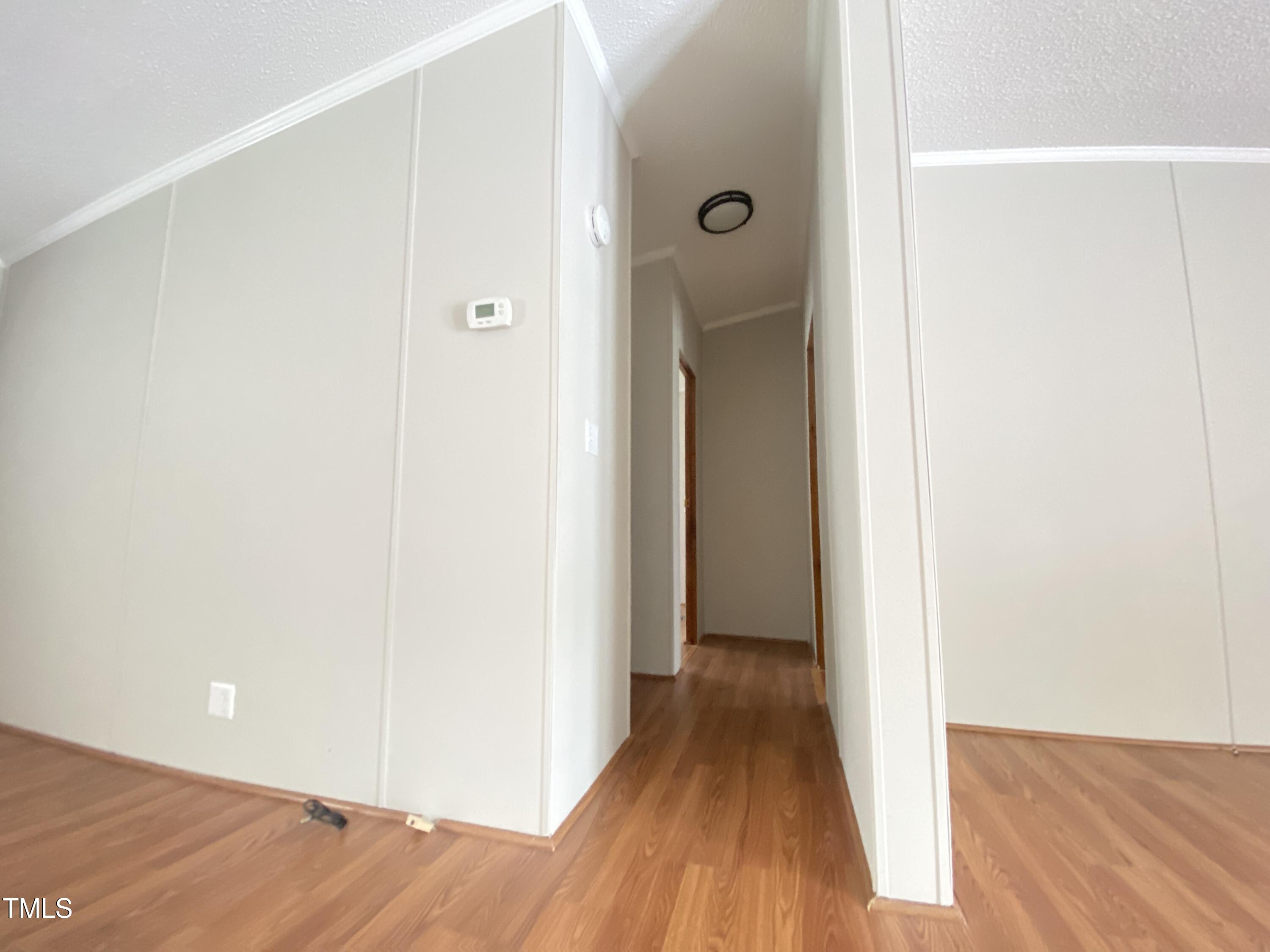 2020 Sanders Road Stem, NC 27581 - Photo 10 of 23 a view of a hallway with wooden floor