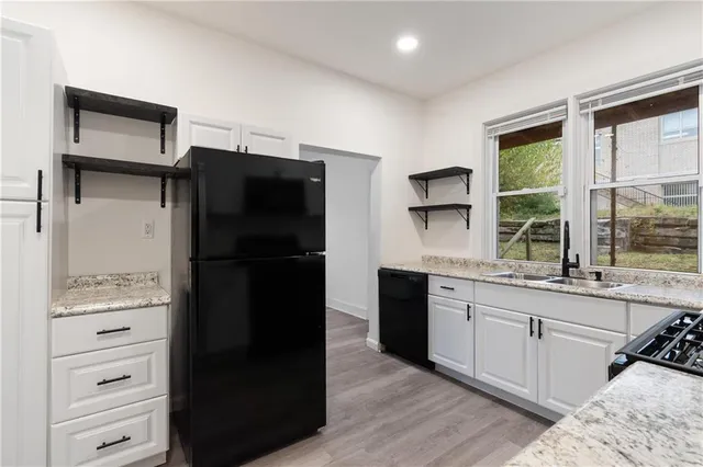 a kitchen with a refrigerator and a sink