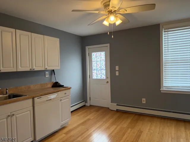 a kitchen with stainless steel appliances granite countertop cabinets and wooden floor