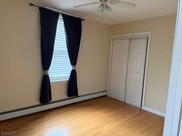 an empty room with wooden floor and entryway