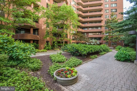 a view of a patio with a table and chairs and potted plants