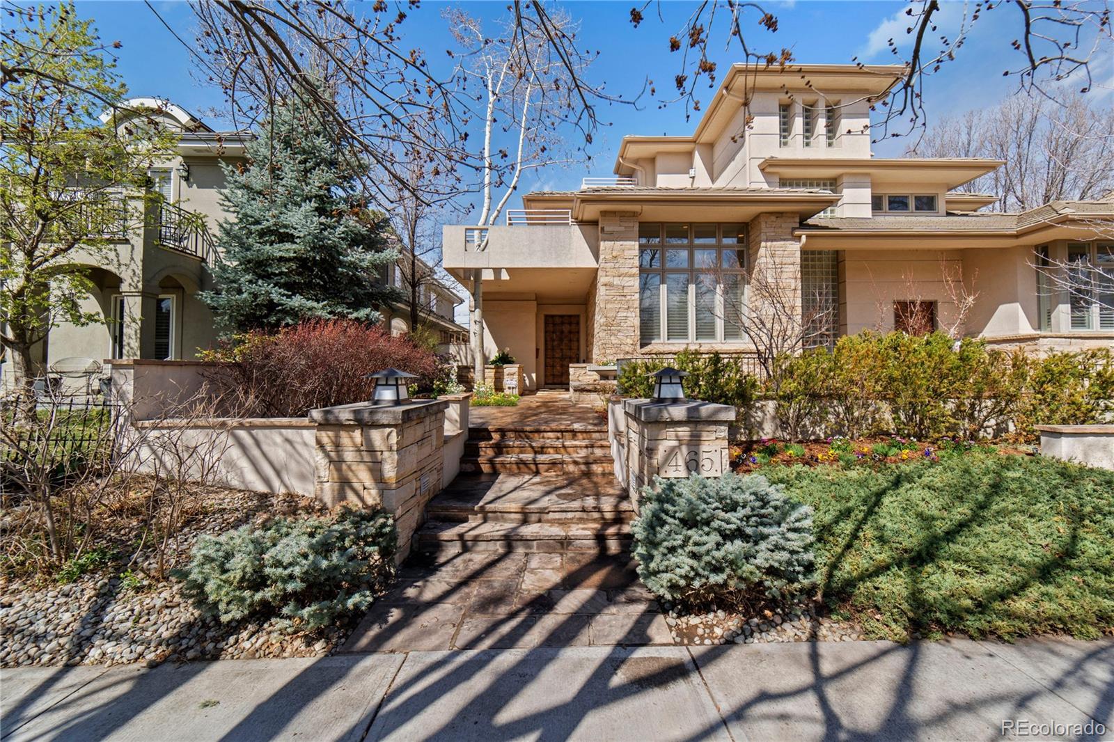 a front view of a house with a tree