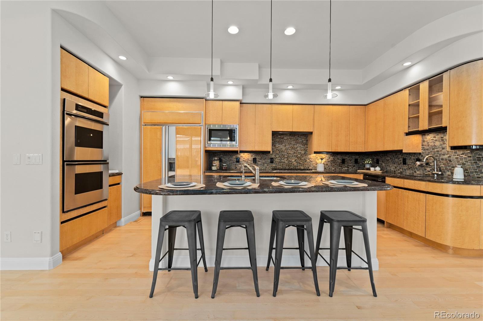 465 Madison Street Denver, CO 80206 - Photo 11 of 40 a kitchen with stainless steel appliances granite countertop a stove a sink and a refrigerator