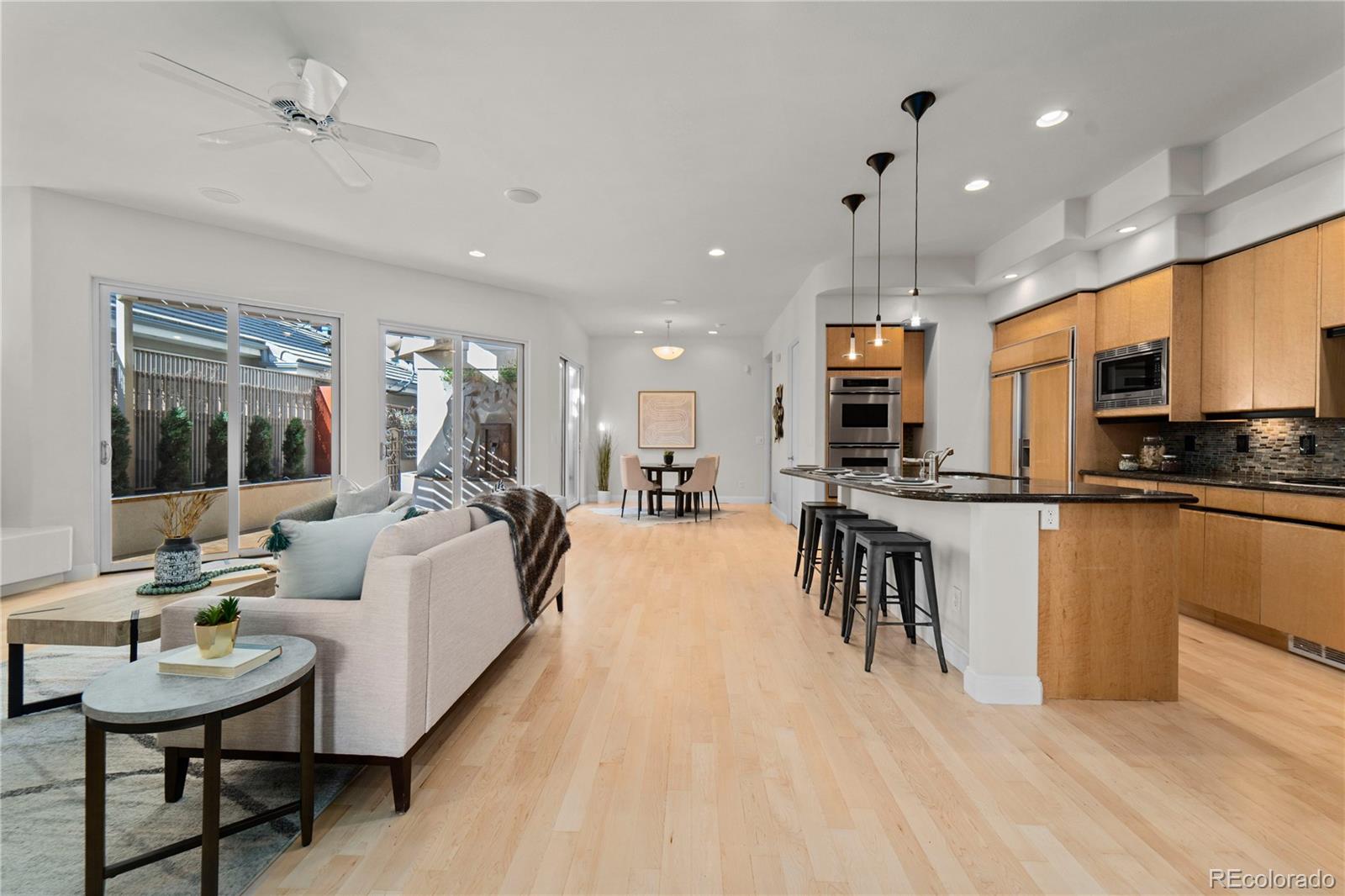 465 Madison Street Denver, CO 80206 - Photo 15 of 40 a living room with furniture a table and kitchen view