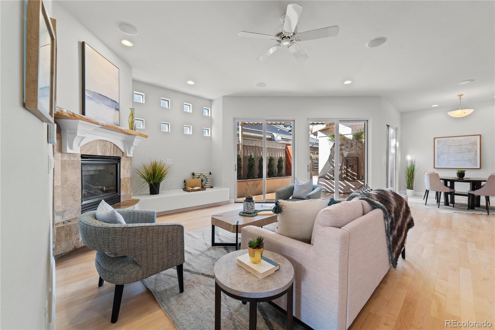 465 Madison Street Denver, CO 80206 - Photo 17 of 40 a living room with furniture a fireplace and a chandelier