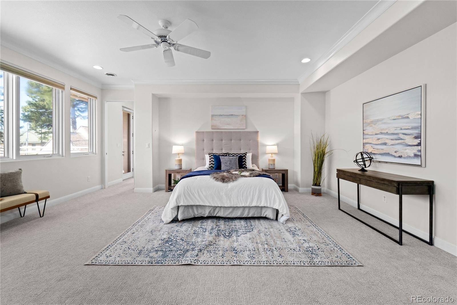 465 Madison Street Denver, CO 80206 - Photo 20 of 40 a spacious bedroom with a bed a couch and large windows