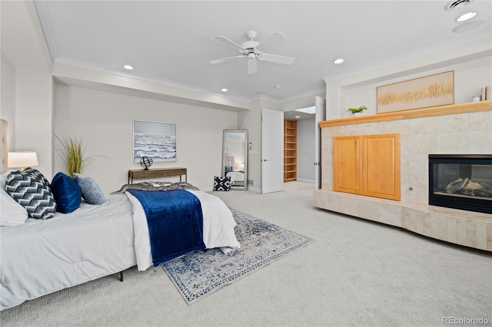 465 Madison Street Denver, CO 80206 - Photo 22 of 40 a bedroom with a large bed and a fireplace