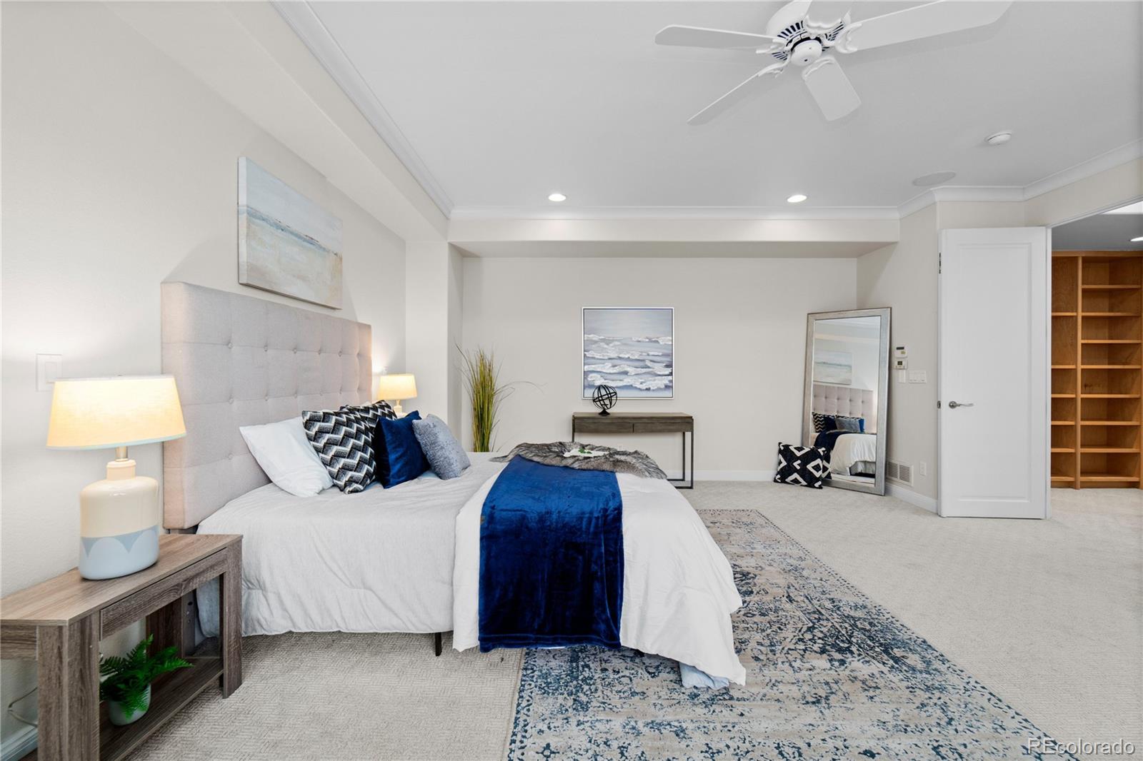 465 Madison Street Denver, CO 80206 - Photo 23 of 40 a bedroom with a bed a mirror and a lamp on dresser
