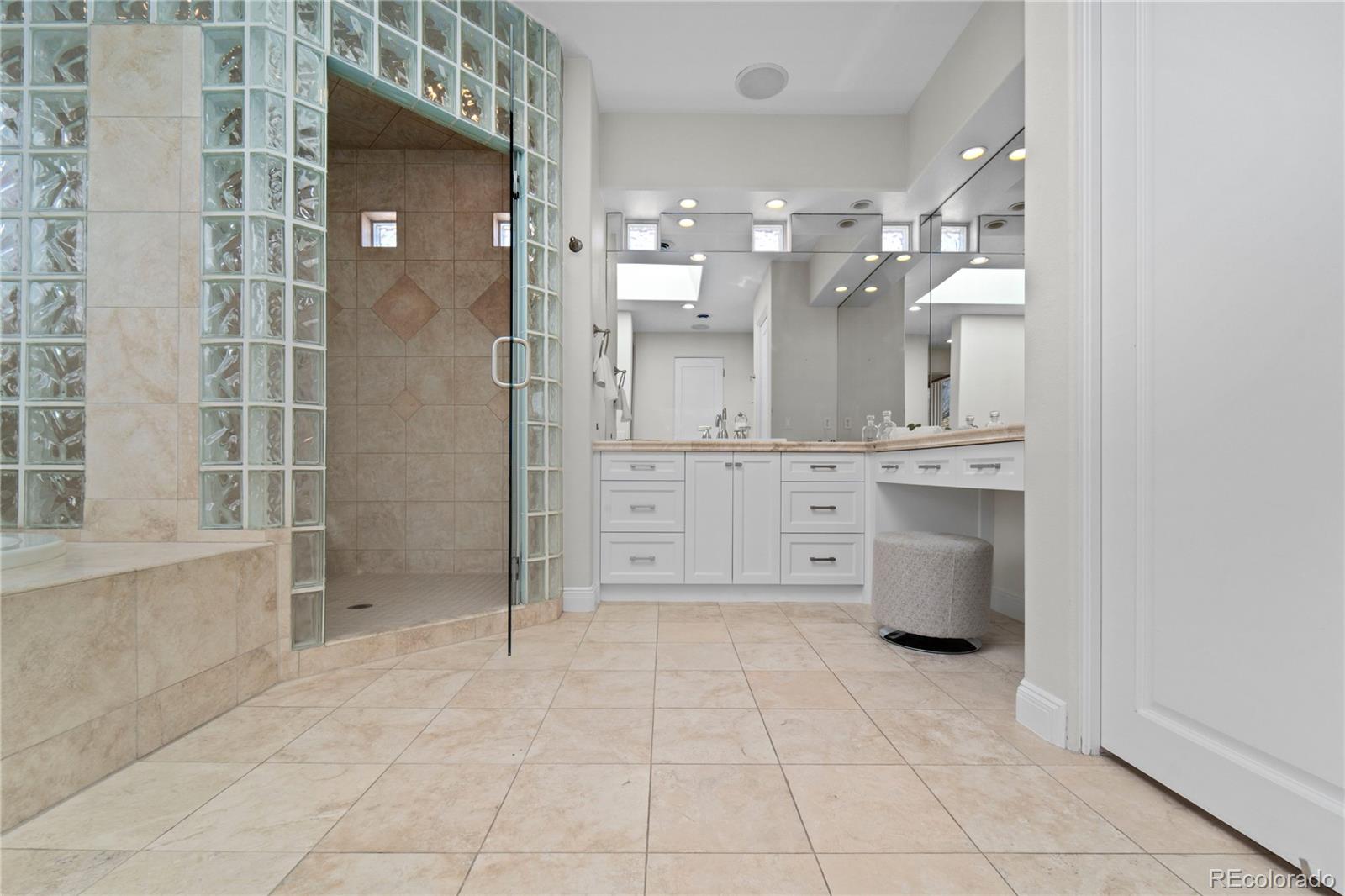 465 Madison Street Denver, CO 80206 - Photo 24 of 40 a large bathroom with a shower a sink and a mirror