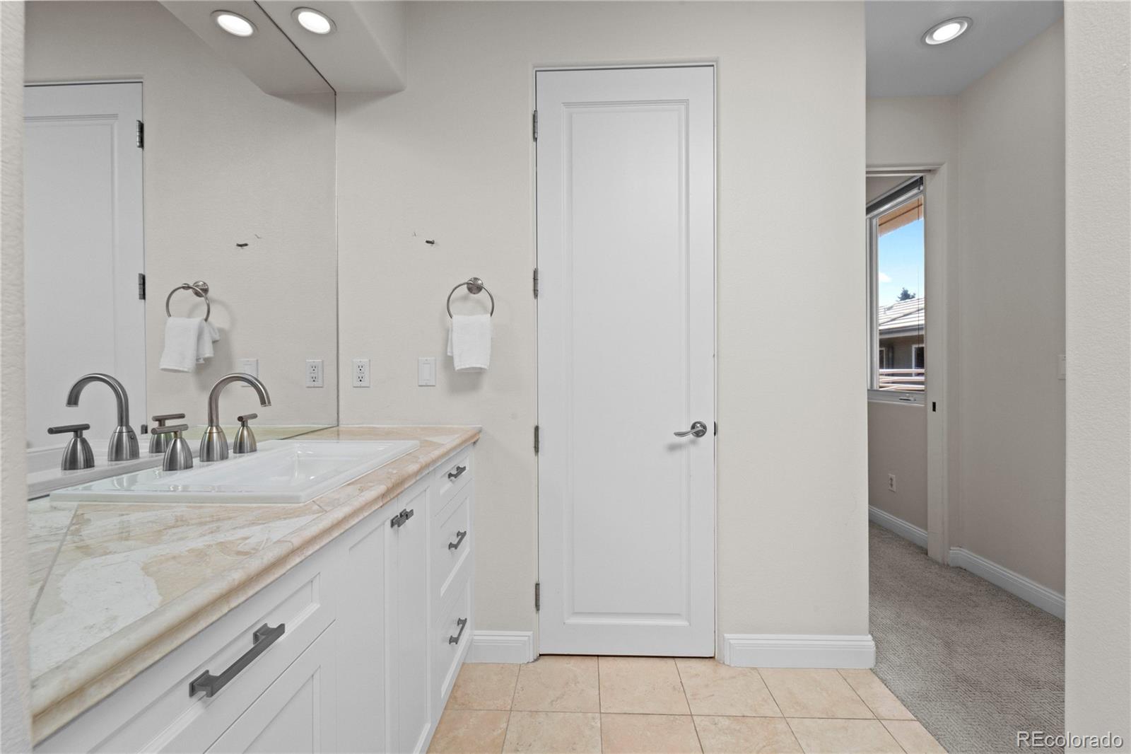 465 Madison Street Denver, CO 80206 - Photo 26 of 40 a bathroom with a granite countertop sink and a mirror