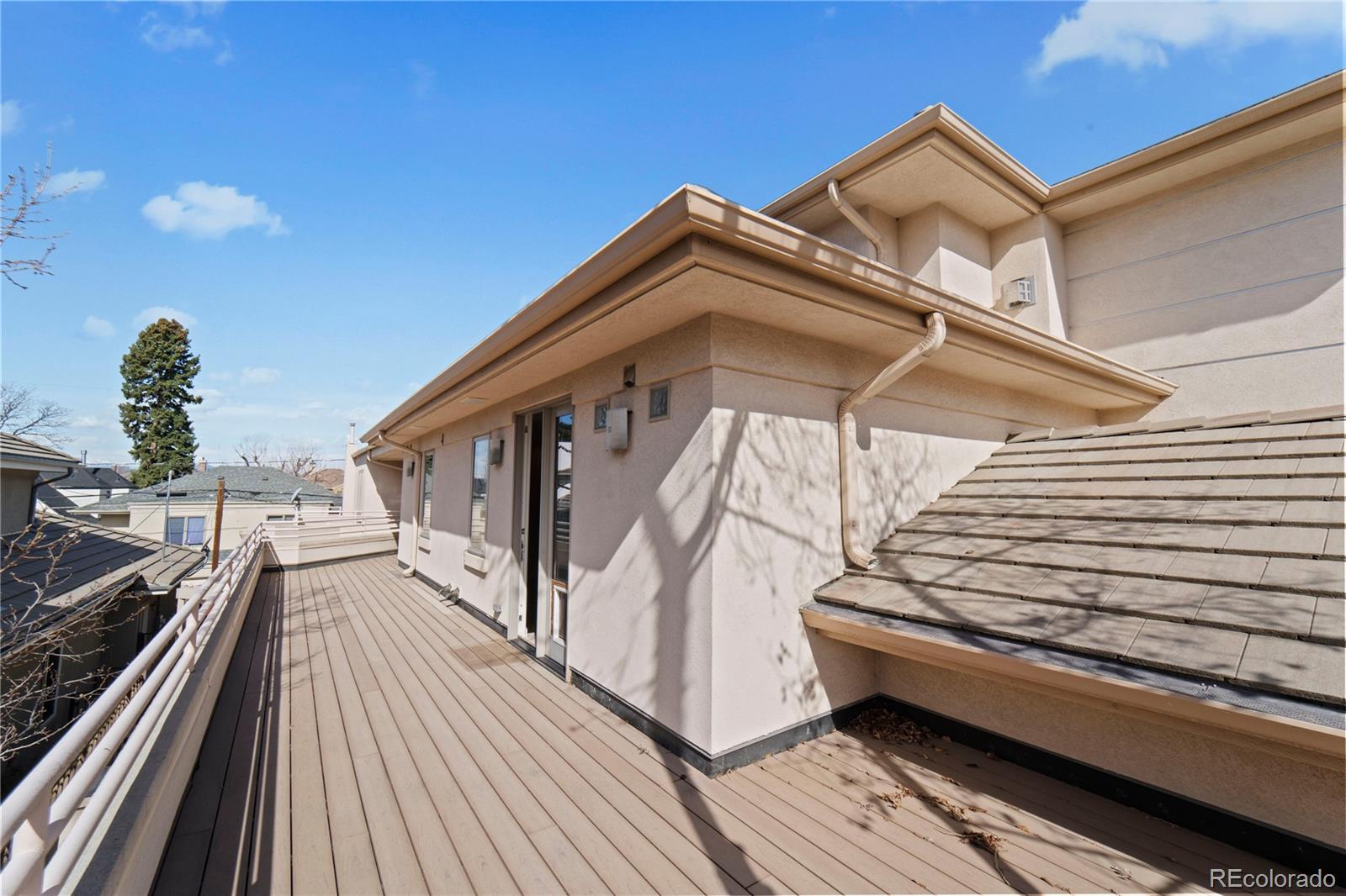 465 Madison Street Denver, CO 80206 - Photo 29 of 40 a view of a house with barbeque and wooden stairs