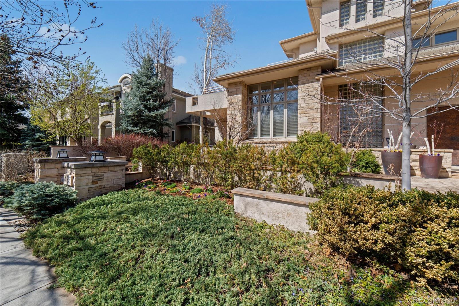 465 Madison Street Denver, CO 80206 - Photo 3 of 40 a view of a house with brick walls and flower plants