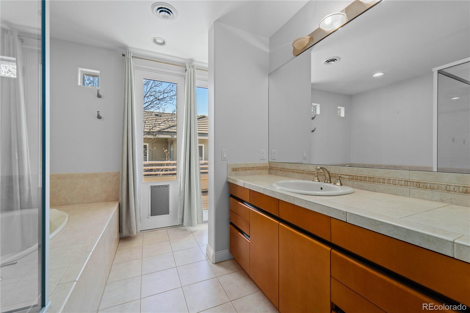 465 Madison Street Denver, CO 80206 - Photo 31 of 40 a bathroom with a granite countertop sink and a mirror