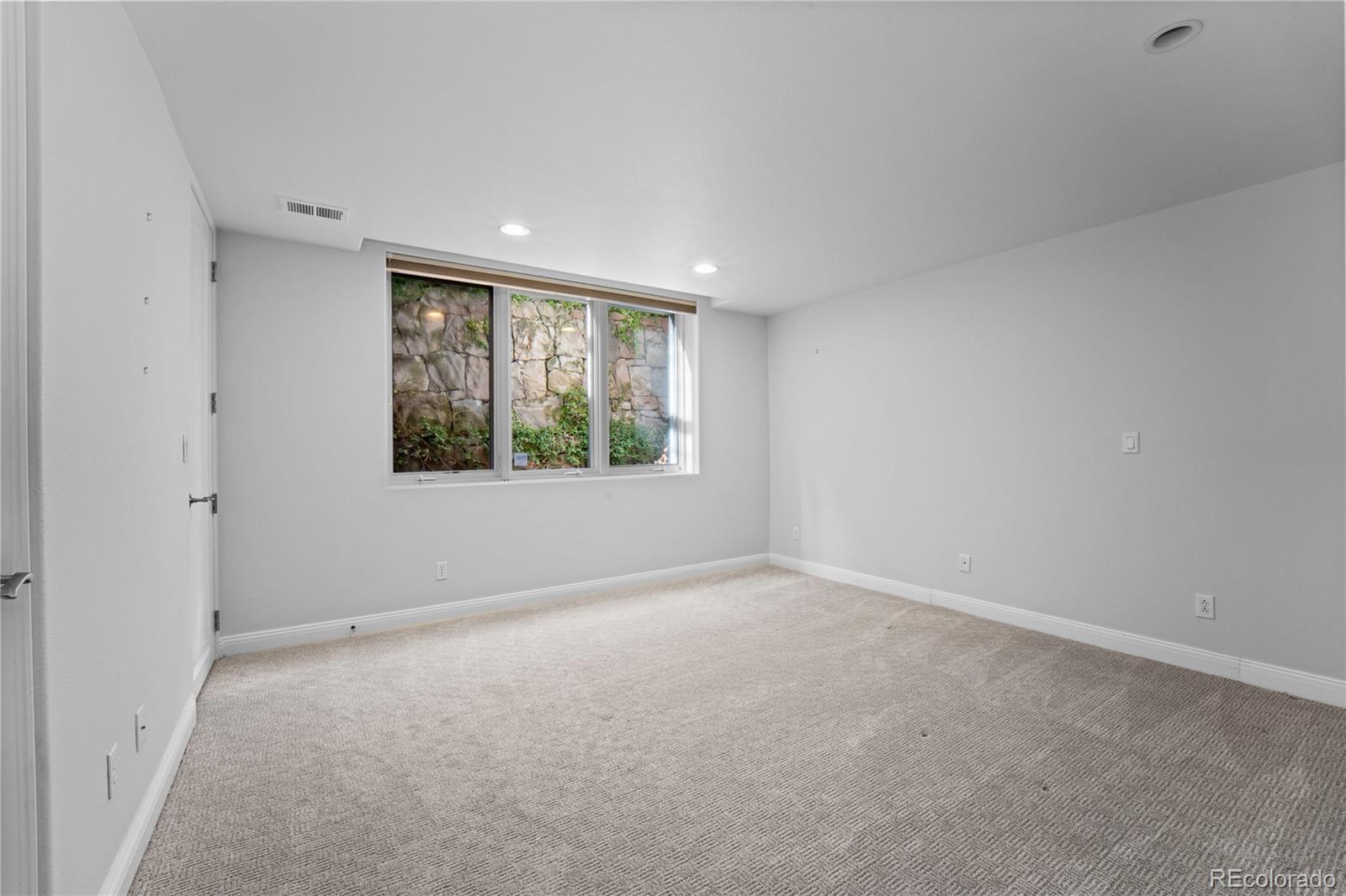 465 Madison Street Denver, CO 80206 - Photo 35 of 40 a view of an empty room with a window