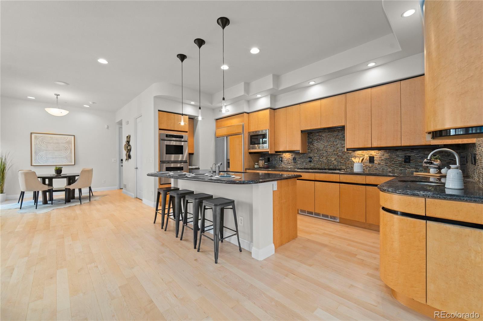 465 Madison Street Denver, CO 80206 - Photo 4 of 40 a kitchen with stainless steel appliances granite countertop a stove a sink a refrigerator and a microwave