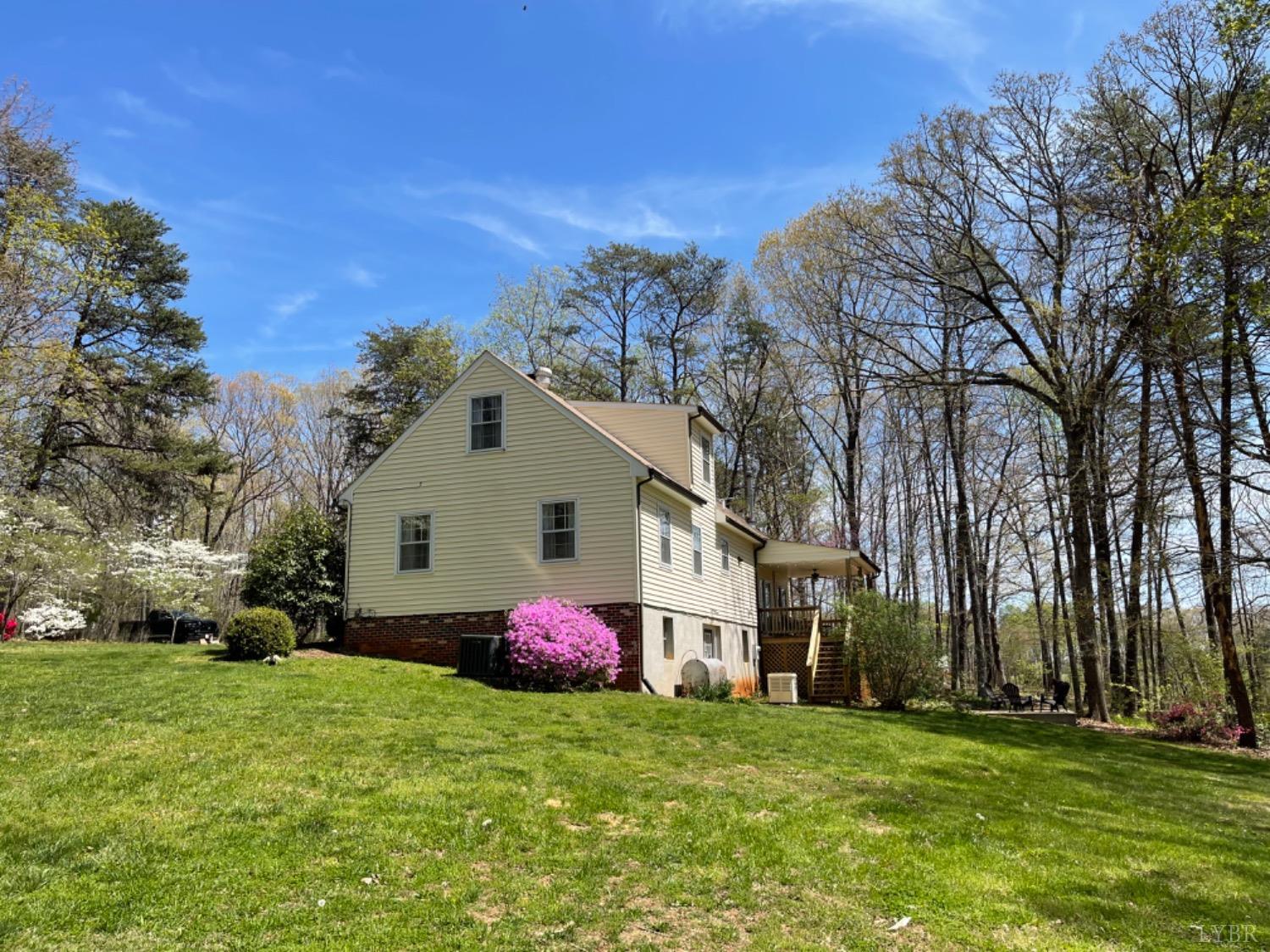 2355 Country Club Road Appomattox, VA 24522 - Photo 12 of 41 a front view of a house with a garden and trees