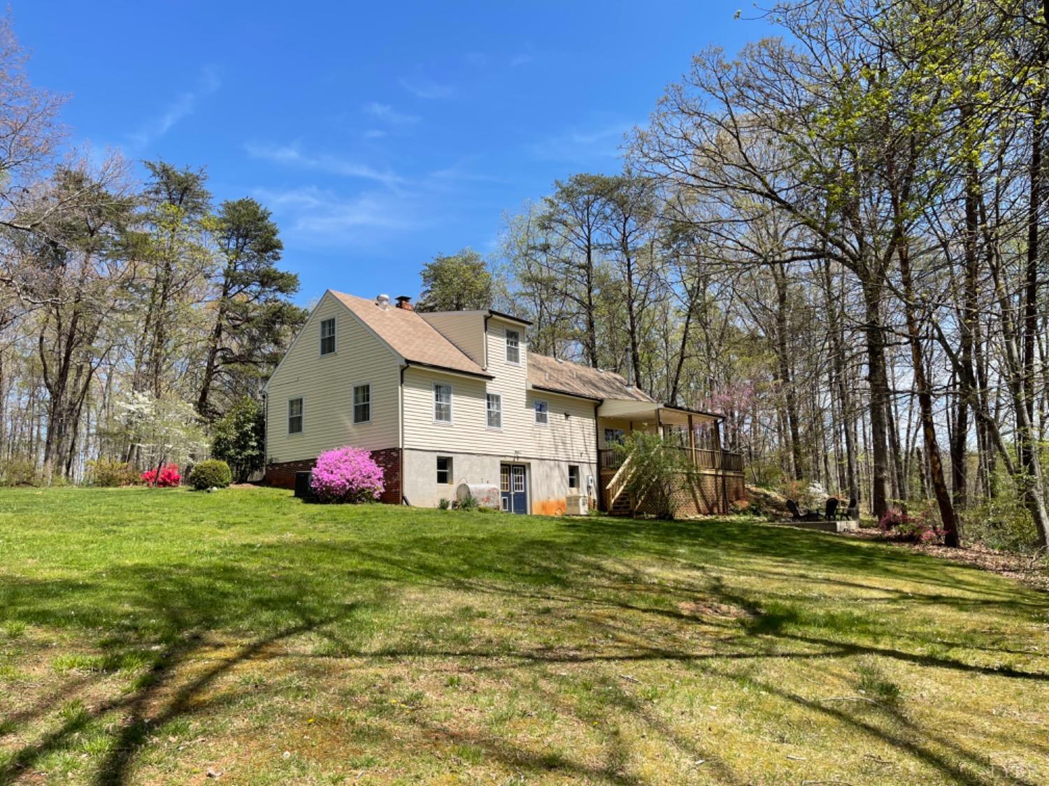 2355 Country Club Road Appomattox, VA 24522 - Photo 13 of 41 a view of a white house with a big yard and large trees