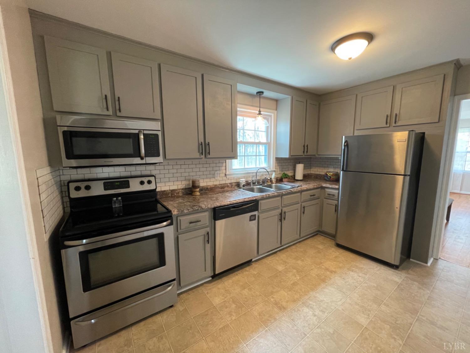 2355 Country Club Road Appomattox, VA 24522 - Photo 23 of 41 a kitchen with a refrigerator stove and microwave