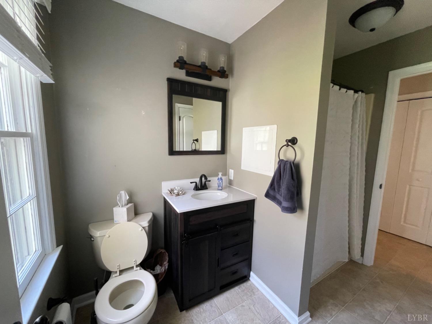 2355 Country Club Road Appomattox, VA 24522 - Photo 32 of 41 a bathroom with a toilet sink and mirror