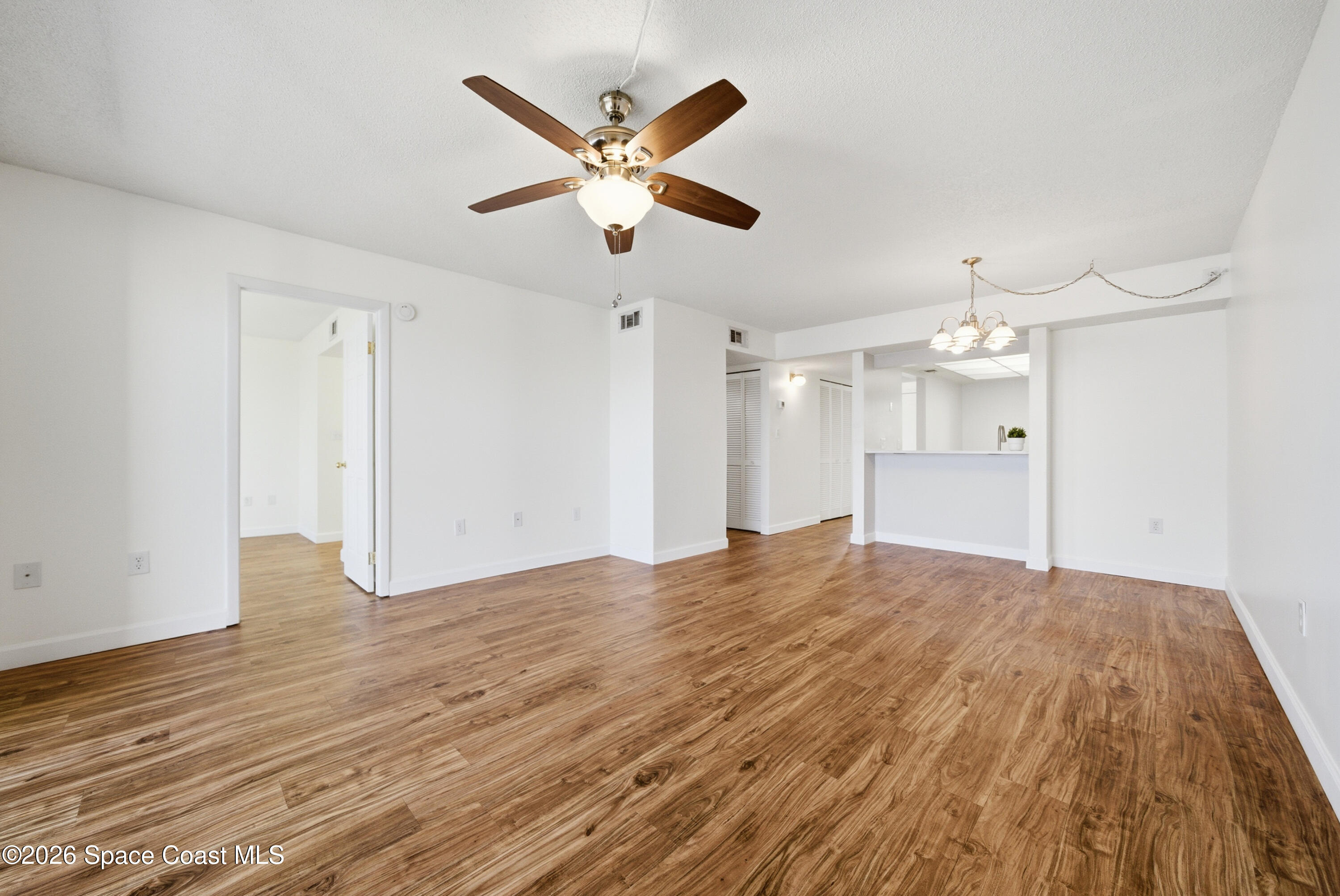 6850 Highway 1, Unit 5204 Grant, FL 32949 - Photo 13 of 33 a view of a livingroom with a chandelier fan and wooden floor