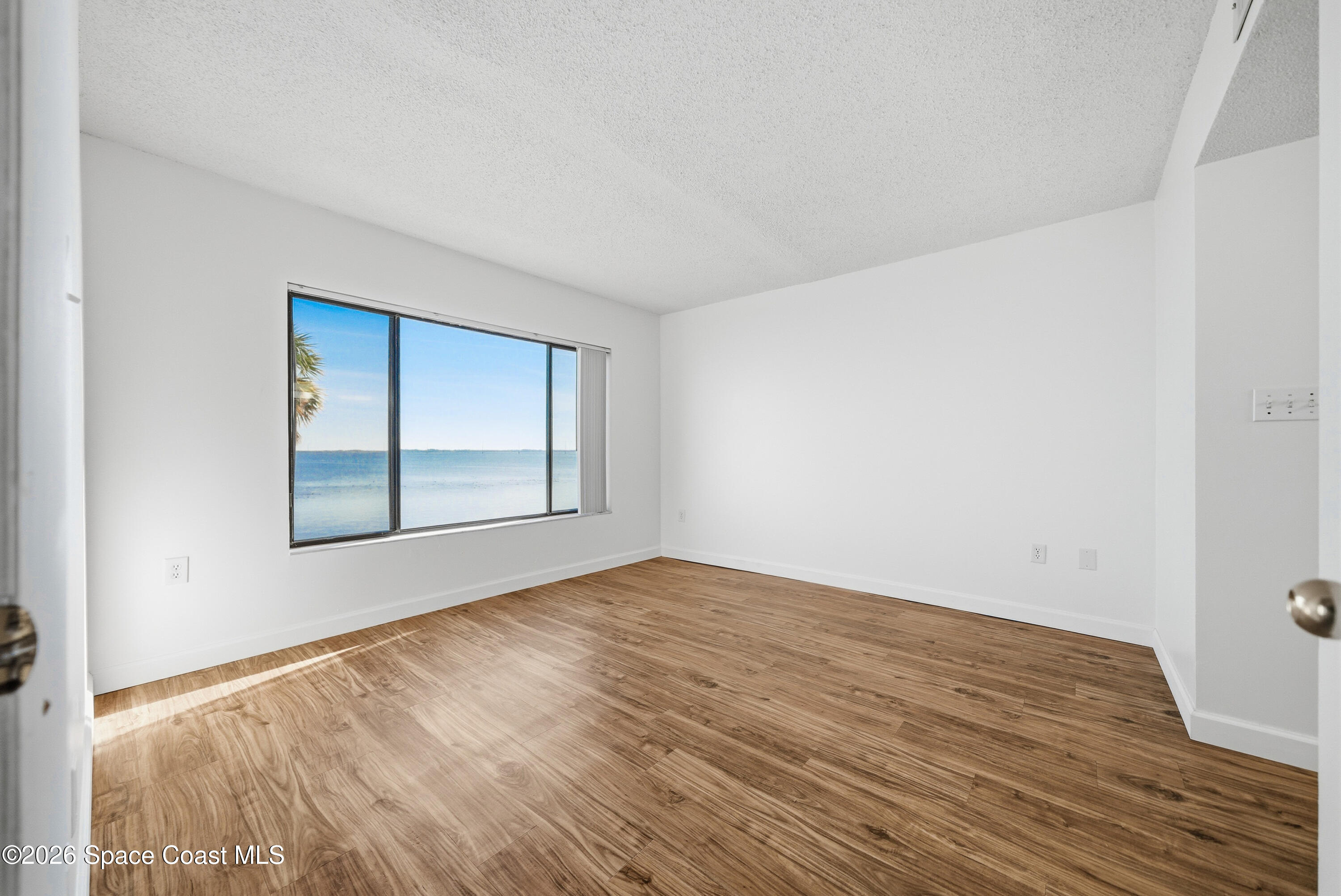 6850 Highway 1, Unit 5204 Grant, FL 32949 - Photo 15 of 33 a view of an empty room with wooden floor and a window