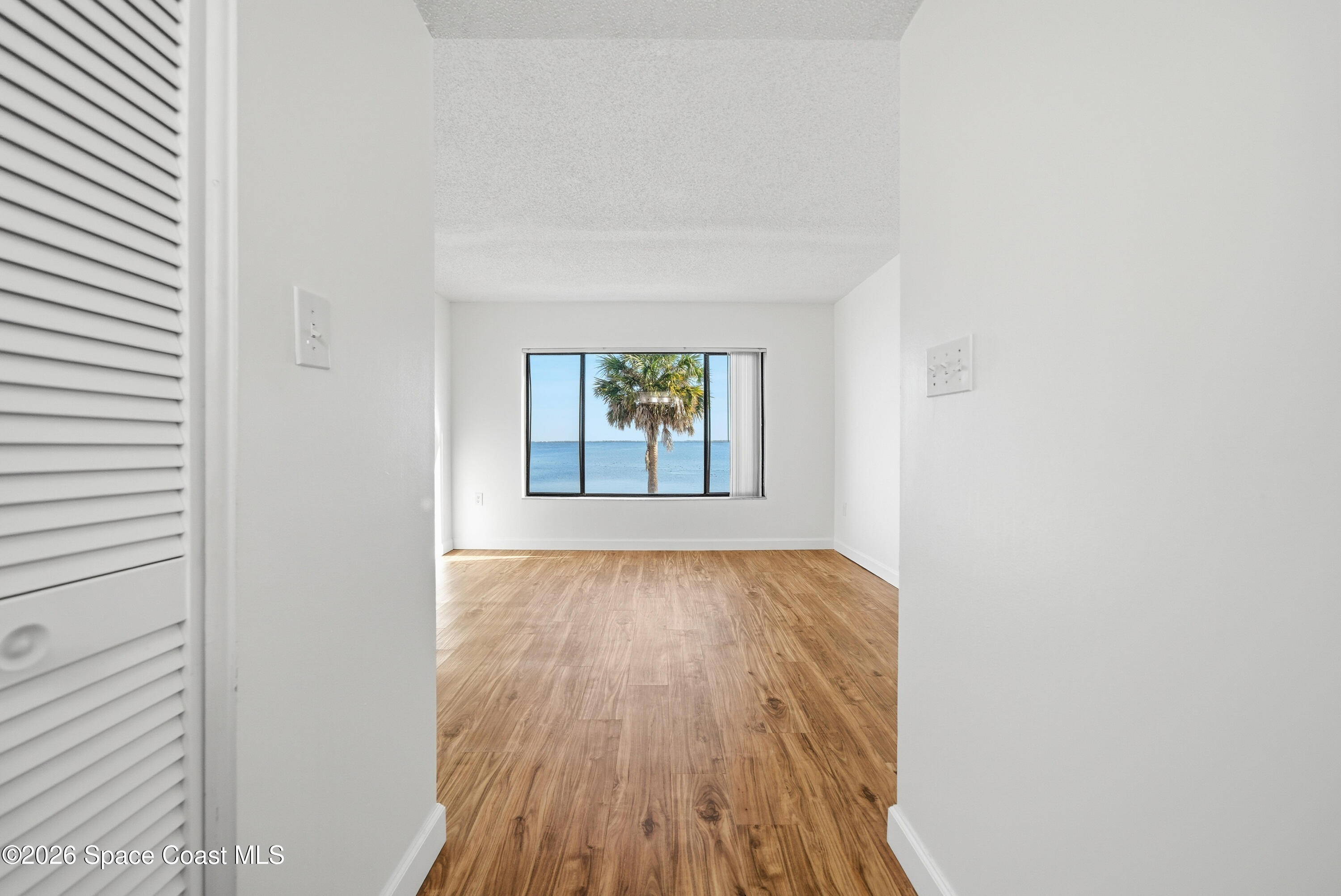 6850 Highway 1, Unit 5204 Grant, FL 32949 - Photo 20 of 33 a view of an empty room with wooden floor and a window