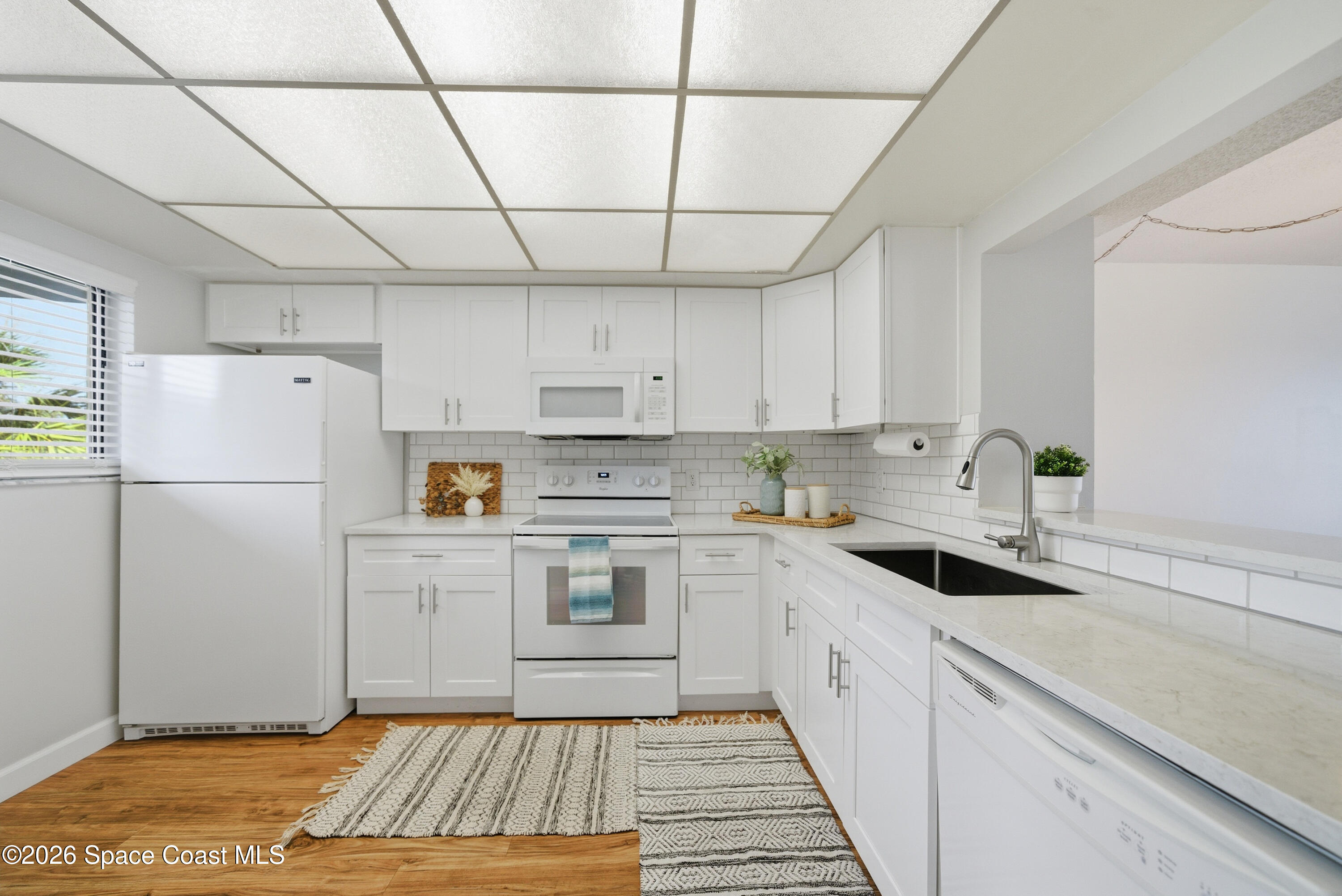 6850 Highway 1, Unit 5204 Grant, FL 32949 - Photo 3 of 33 a kitchen with a sink a refrigerator and cabinets