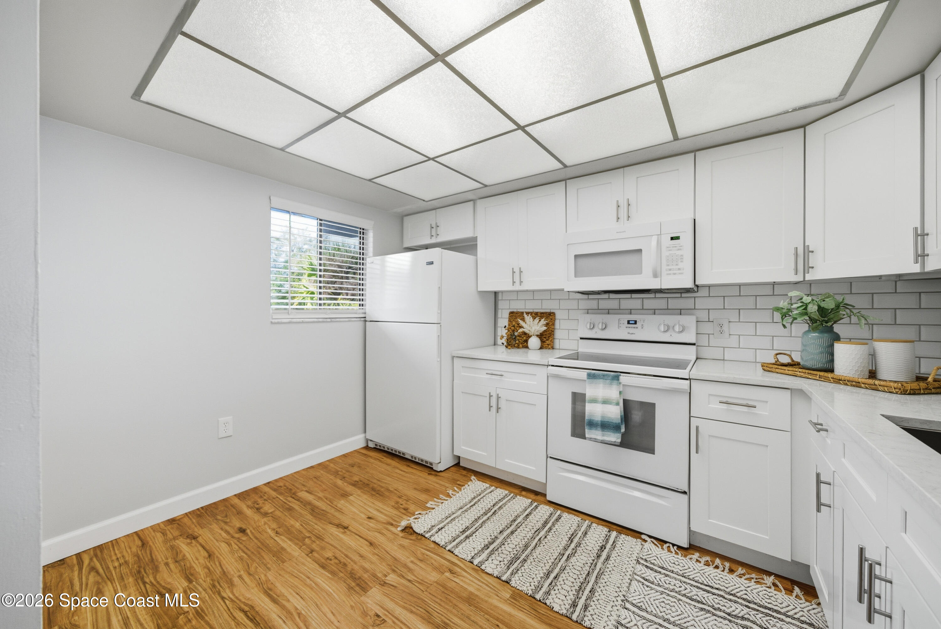 6850 Highway 1, Unit 5204 Grant, FL 32949 - Photo 4 of 33 a kitchen with stainless steel appliances granite countertop a sink a stove a refrigerator white cabinets and wooden floor
