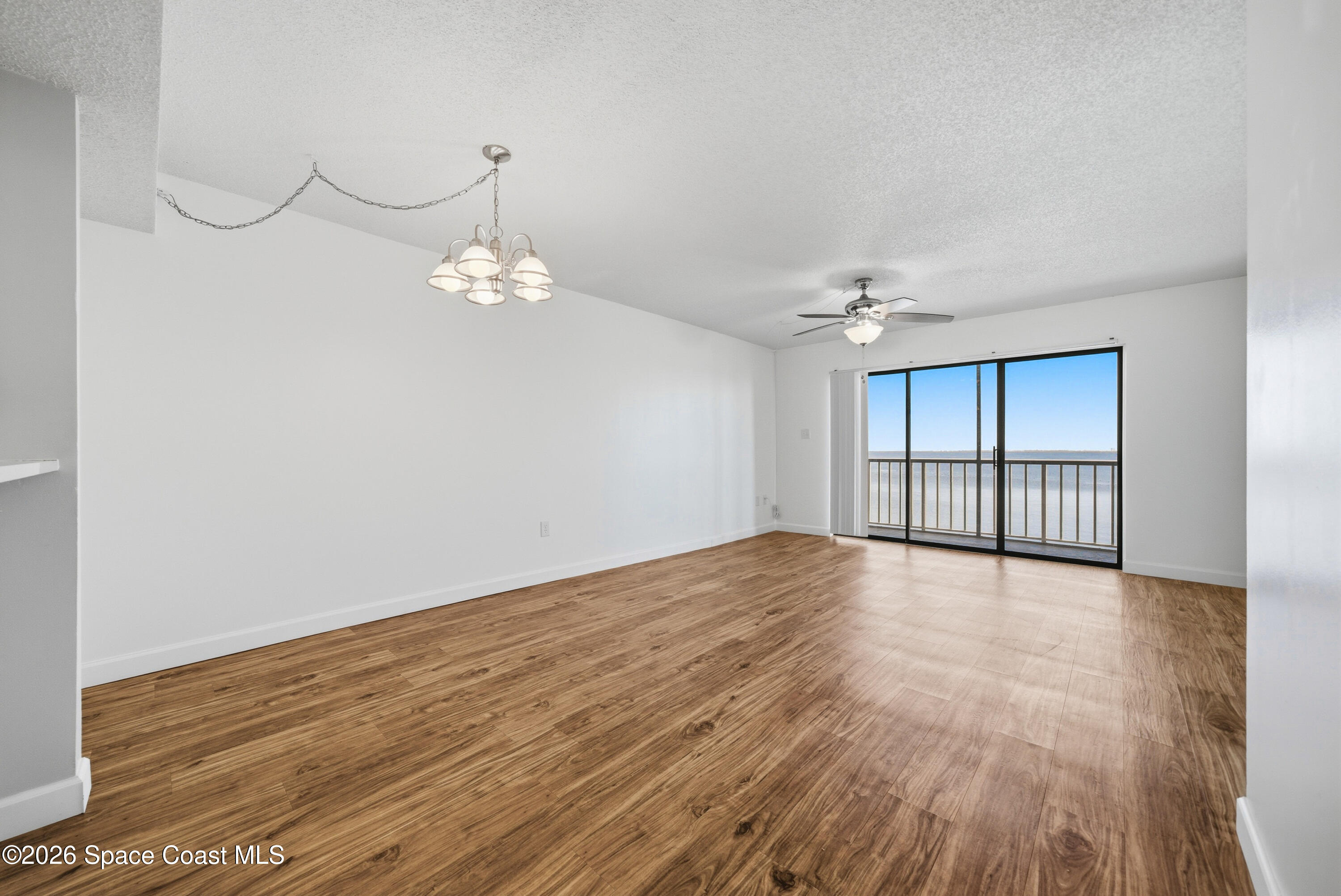 6850 Highway 1, Unit 5204 Grant, FL 32949 - Photo 7 of 33 a view of an empty room with wooden floor and a window