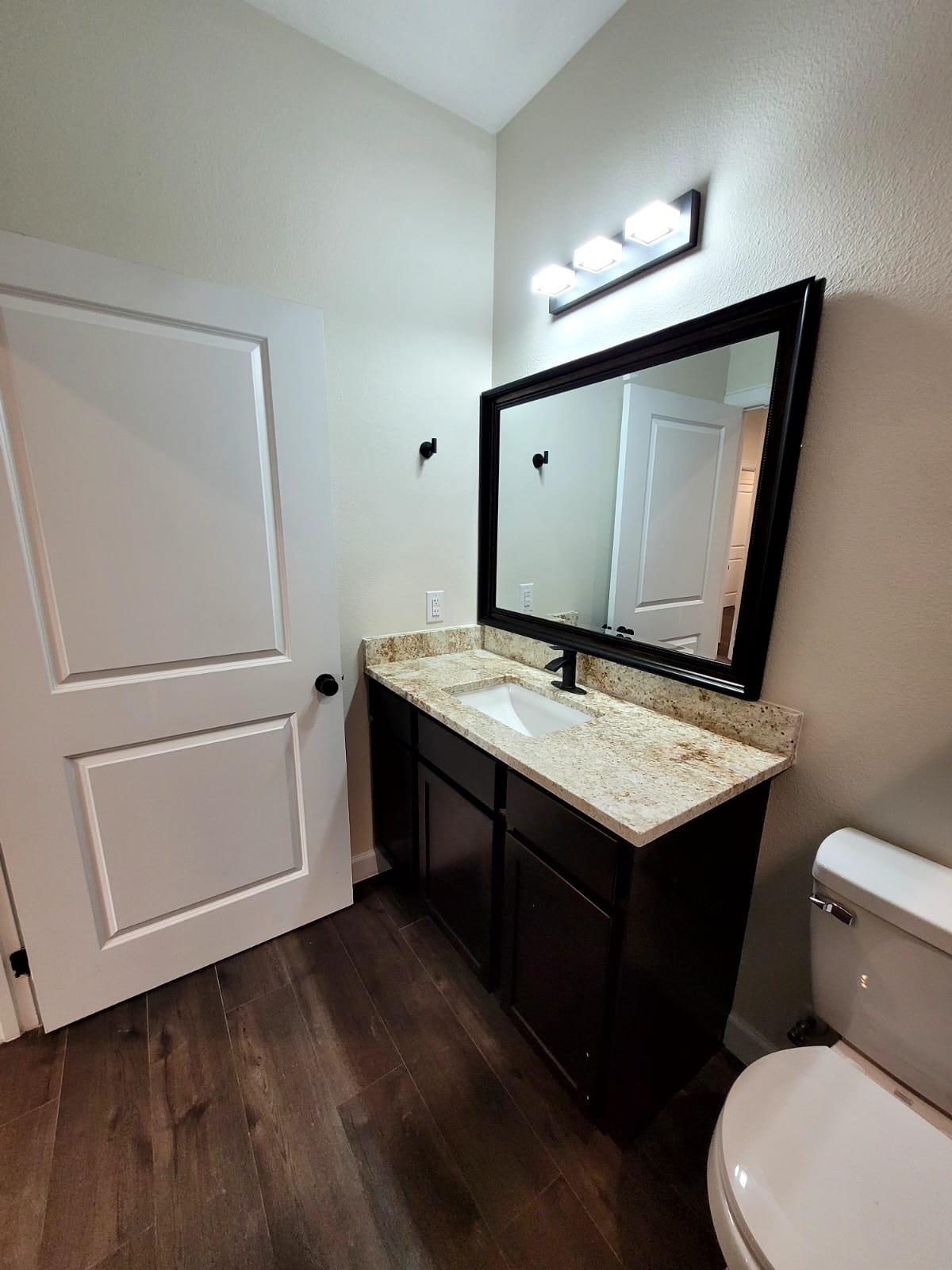 750 South Main Street Lockhart, TX 78644 - Photo 21 of 31 Bathroom with dark wood-style floors and vanity